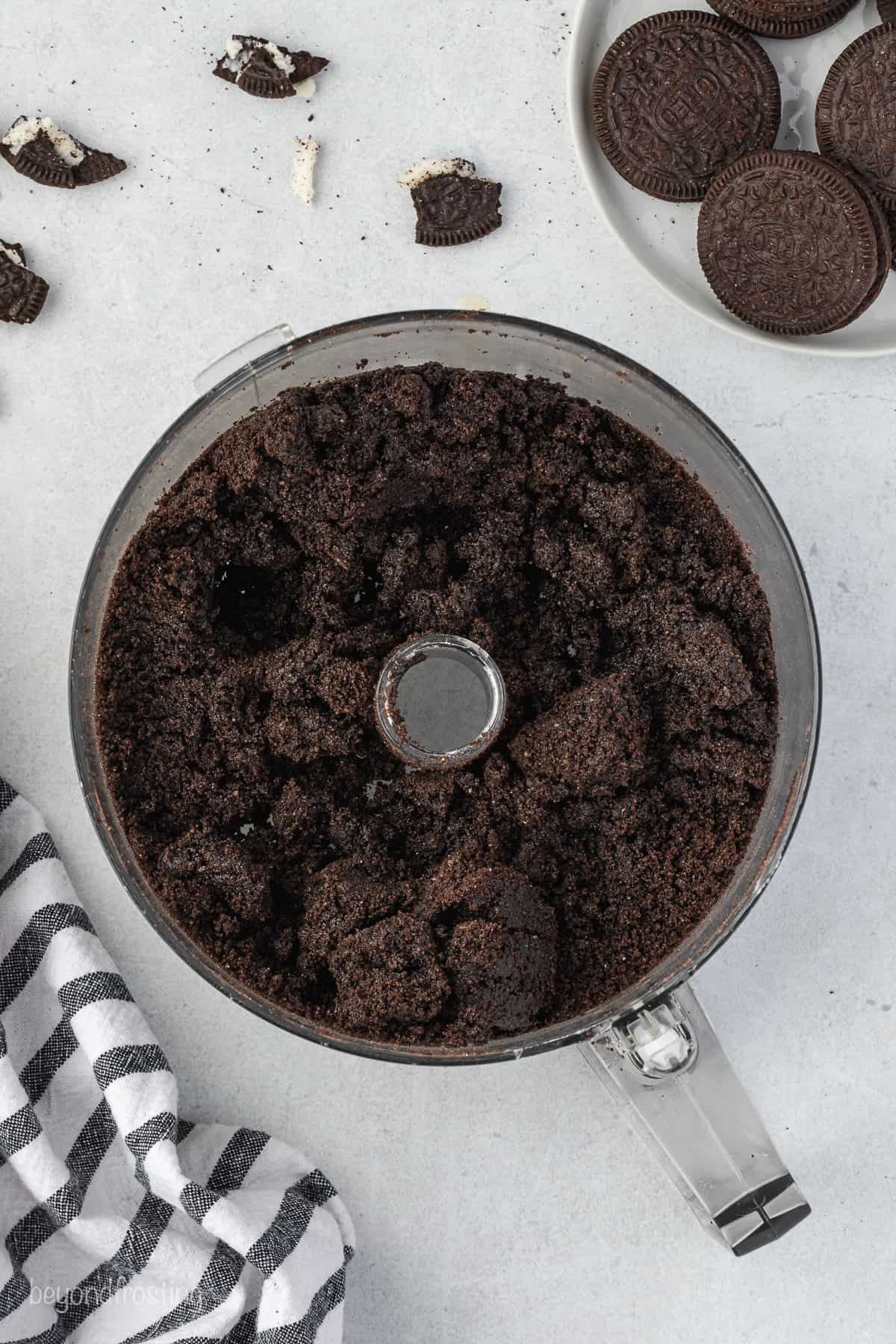 food processor with crushed Oreos and butter