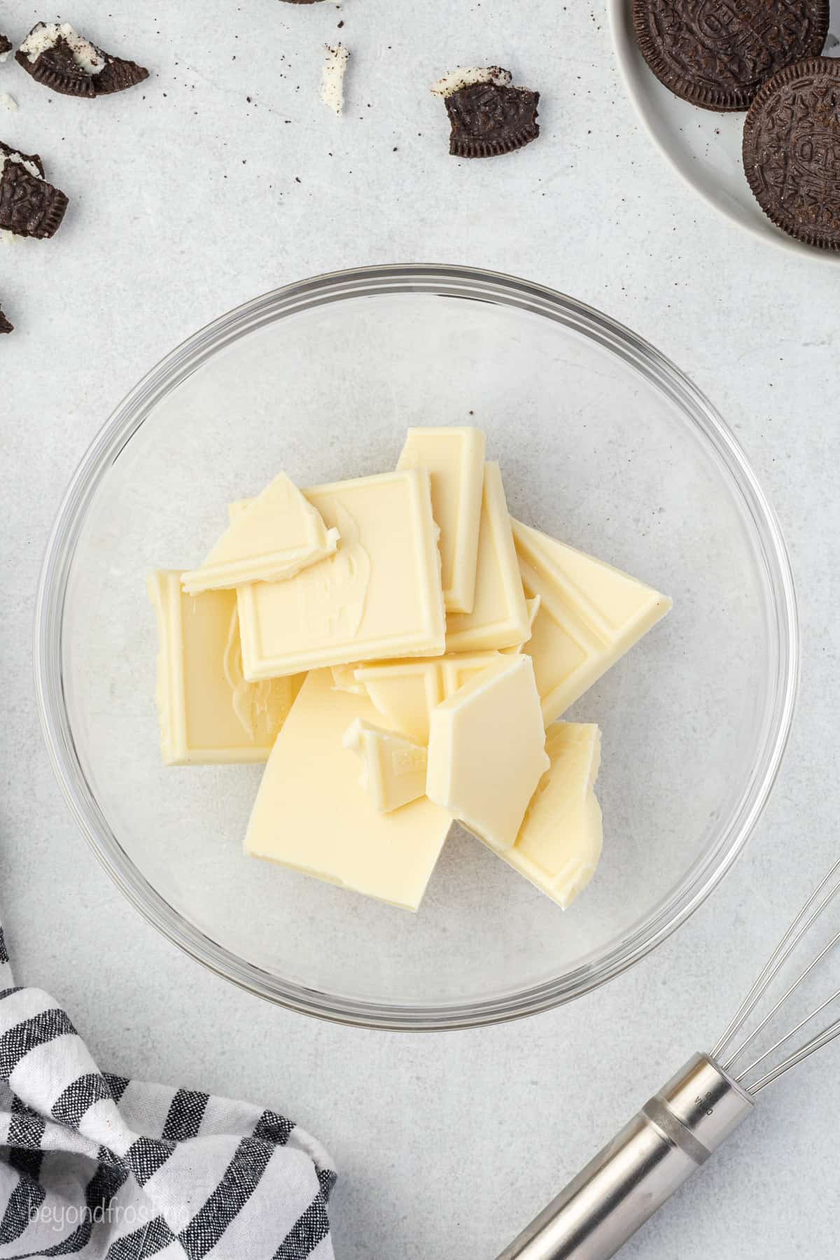 broken pieces of white chocolate in a glass bowl