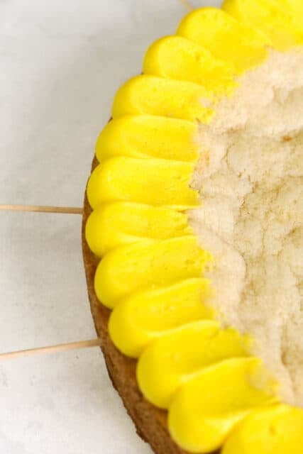 Close up of yellow buttercream pedal frosting technique on a cookie cake