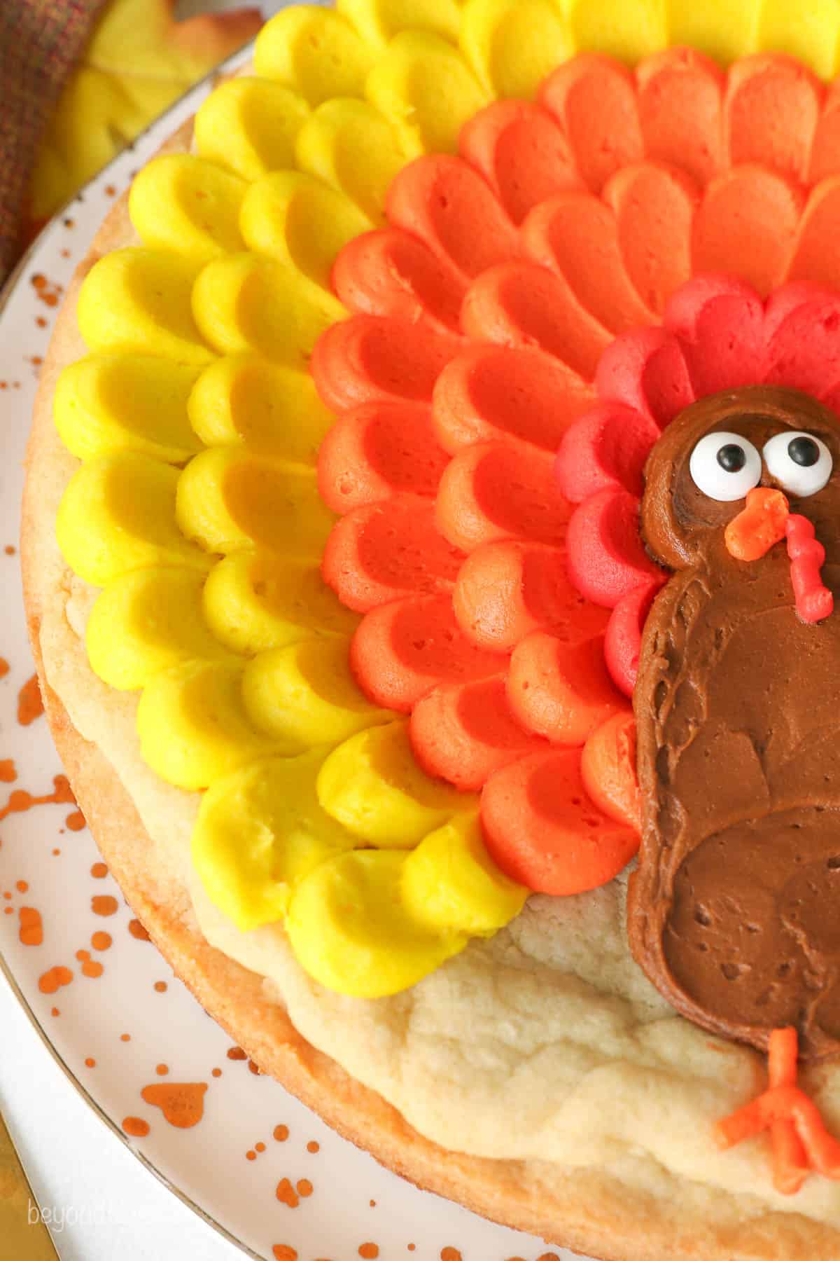 Close up of a cookie cake decorated with buttercream to look like a turkey