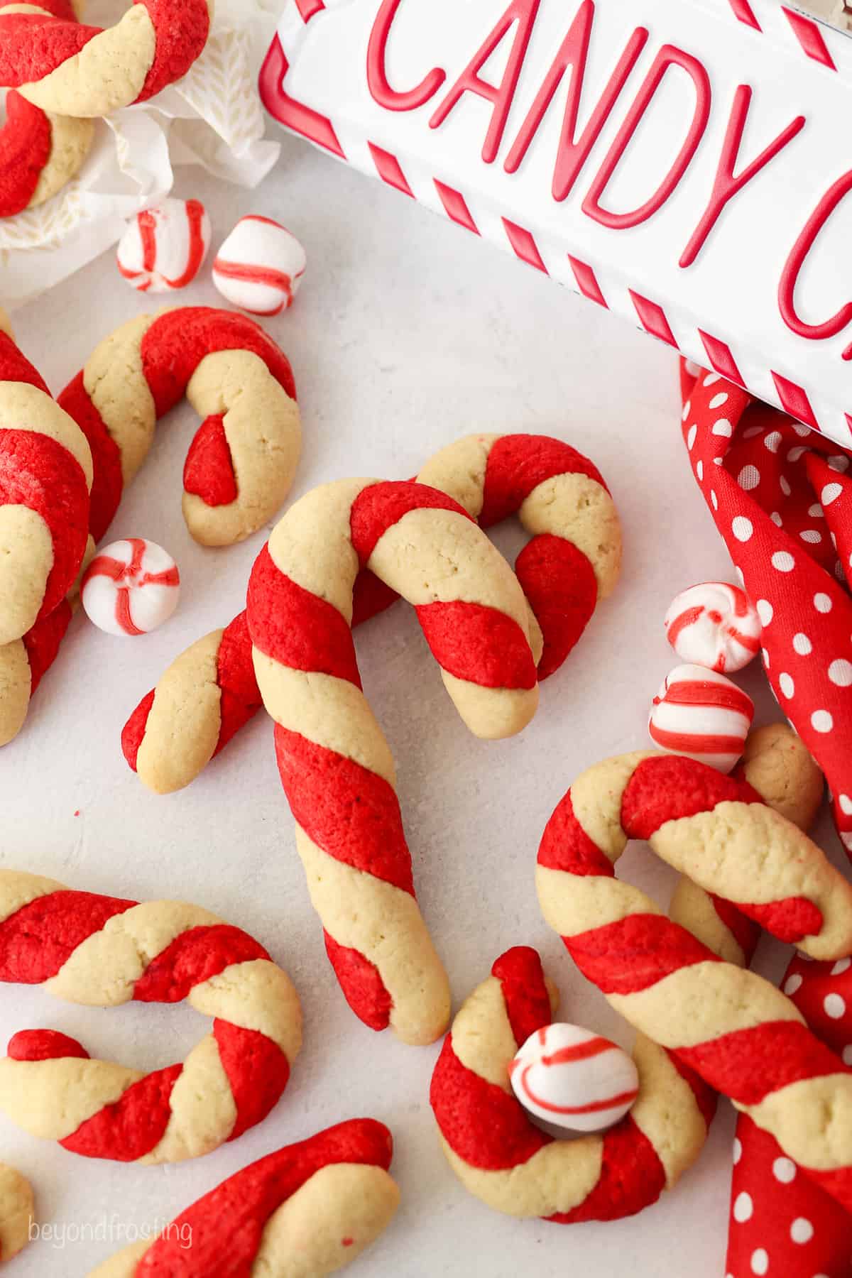 Assorted candy cane cookies on a white countertop.