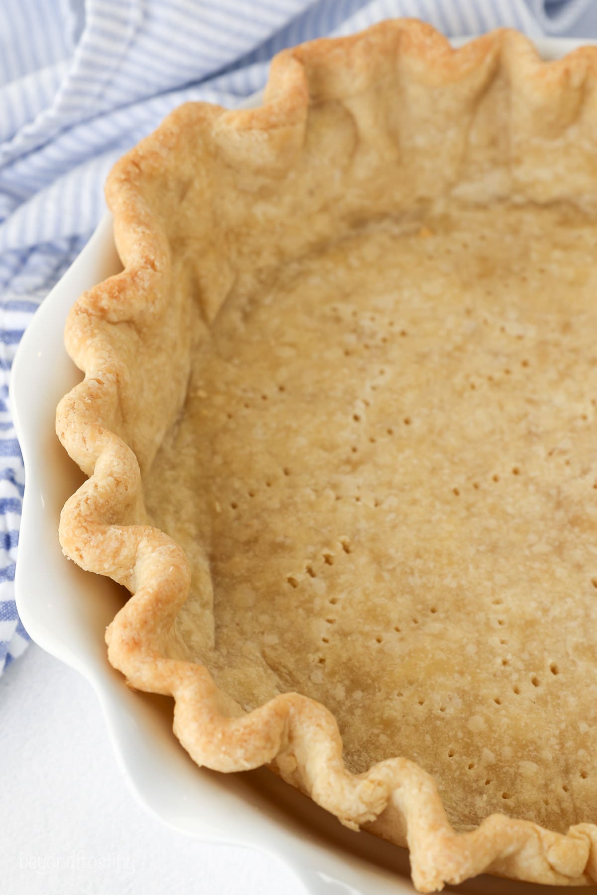 A fully baked pie crust in a pie plate.