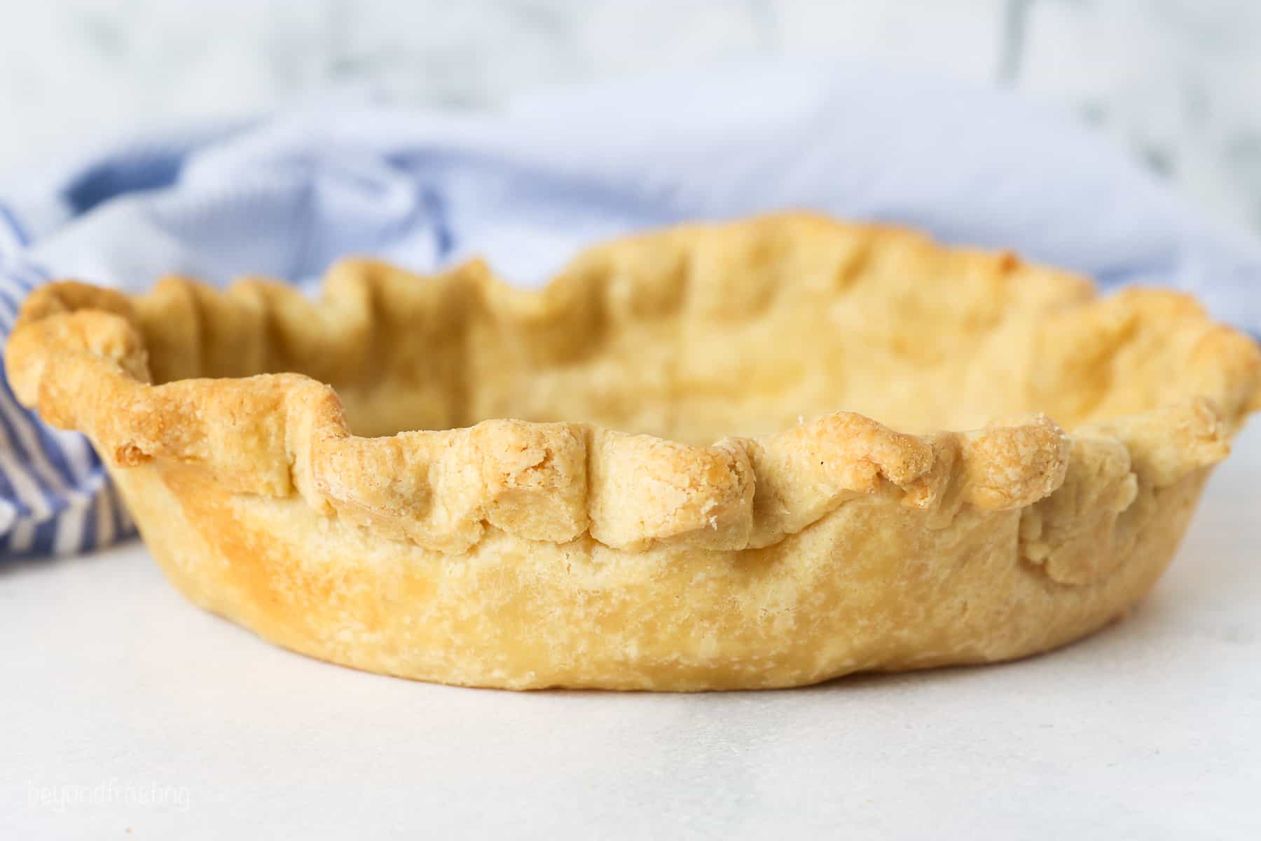 Side view of a baked pie crust outside of the pie plate.