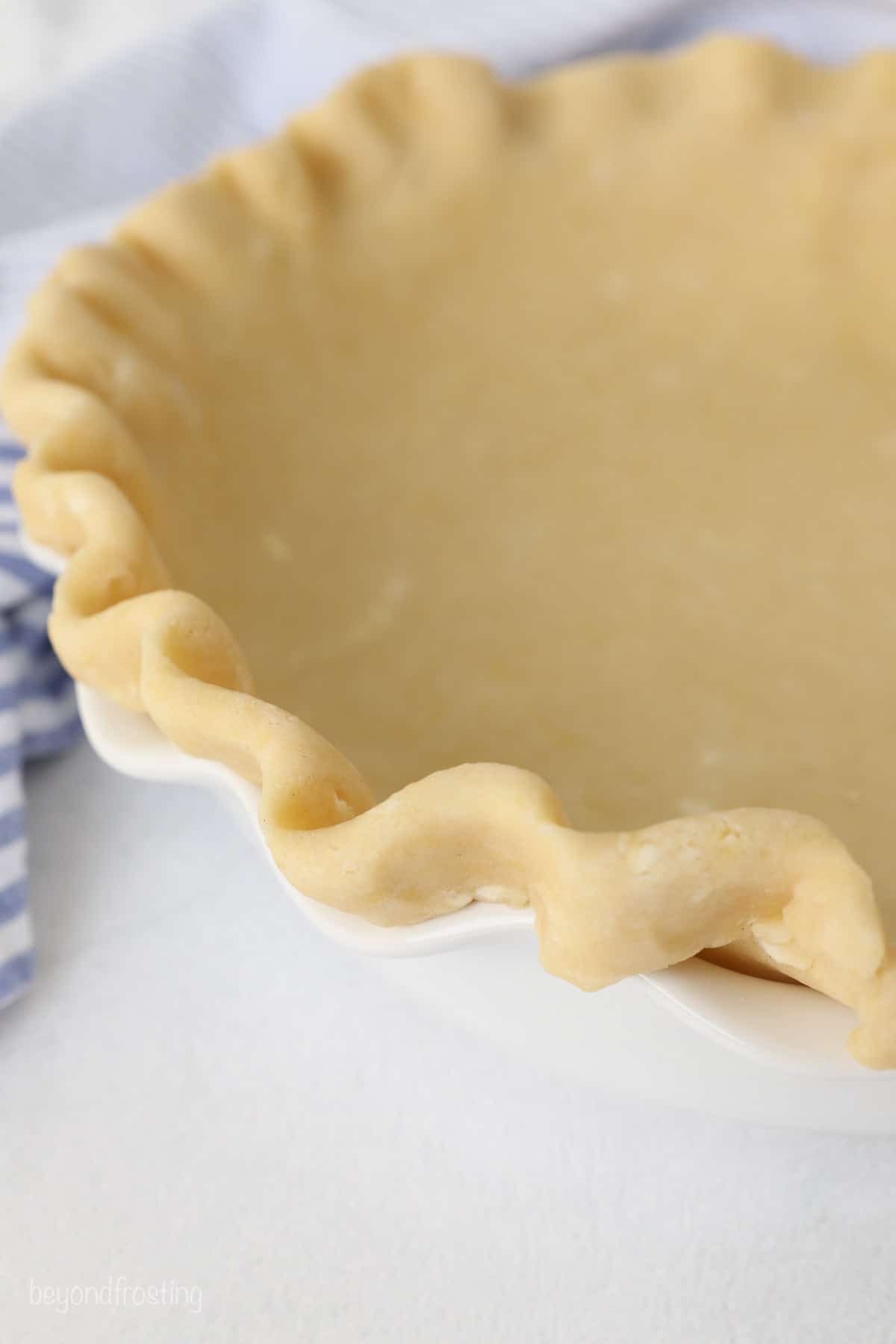 Unbaked pie crust in a pie plate.