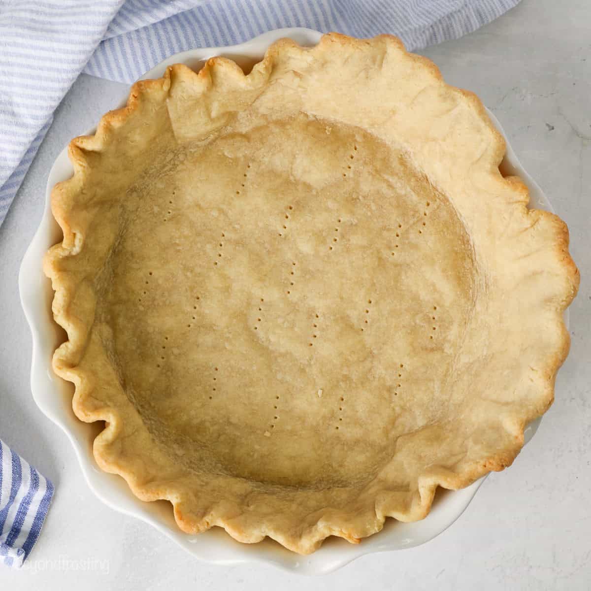 Overhead view of a fully baked pie crust in a pie plate.