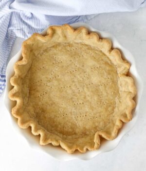 Overhead view of a fully baked pie crust in a pie plate.