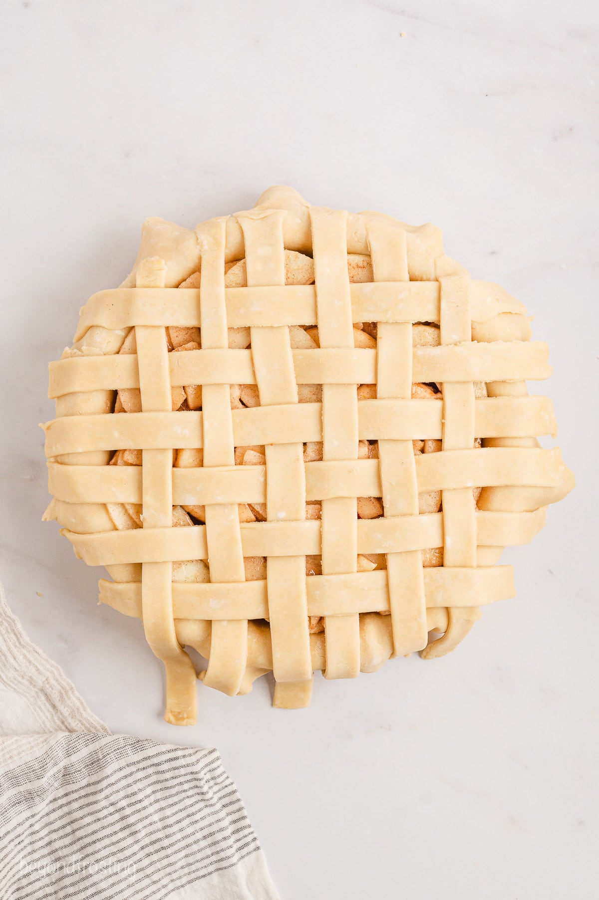Lattice strips woven over a filled pie crust.