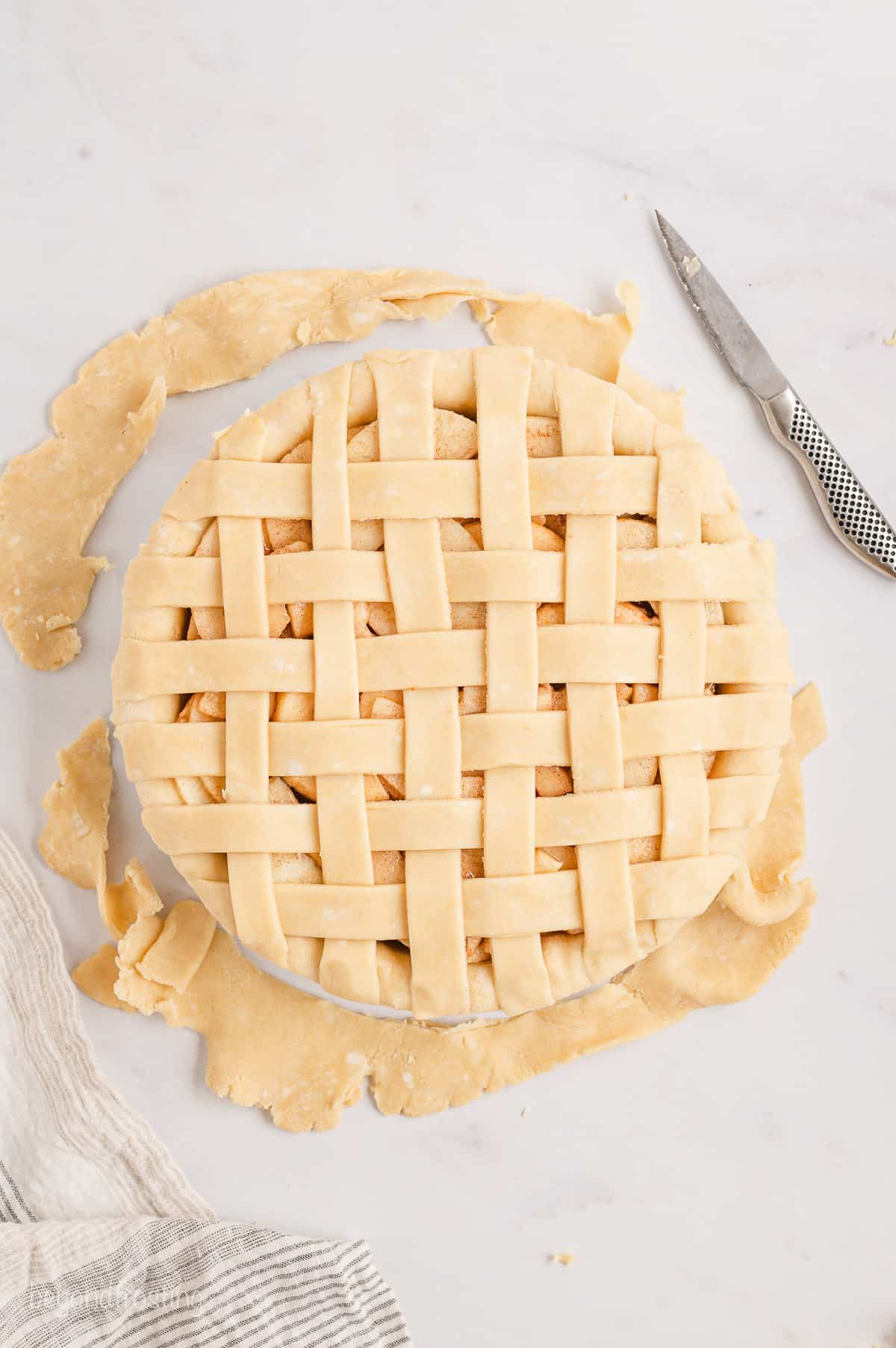 Trimmed lattice strips woven over a filled pie crust.