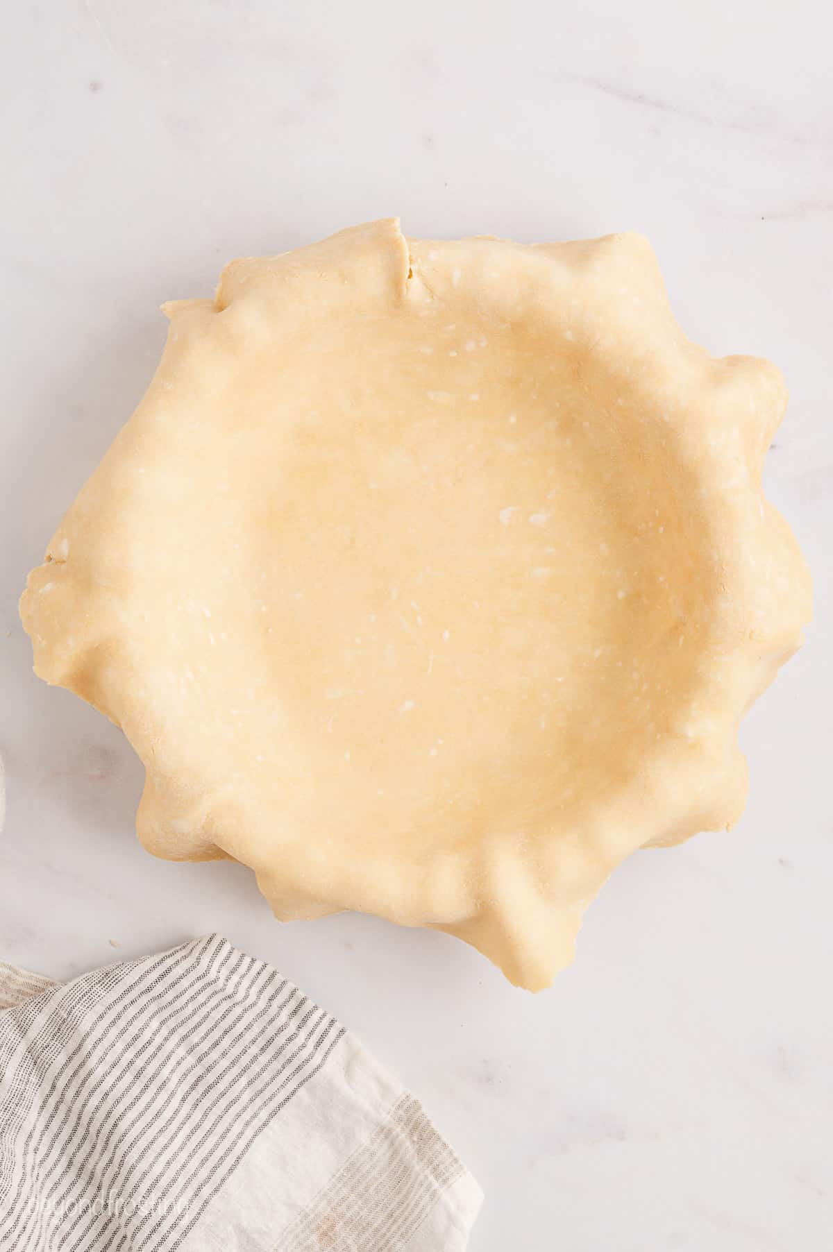 One half of a pie crust pressed into a pie plate.