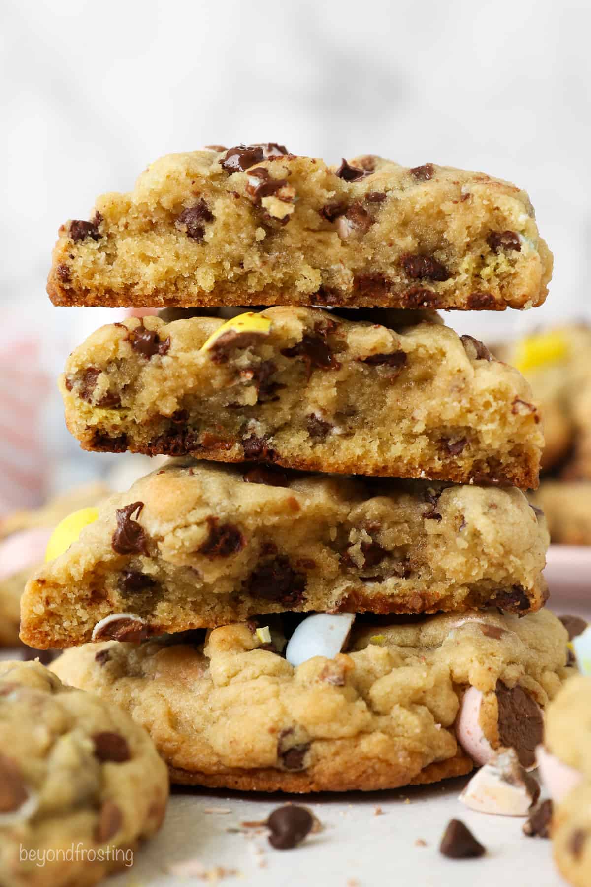 A stack of broken chocolate chip cookies showing you the inside of the cookie