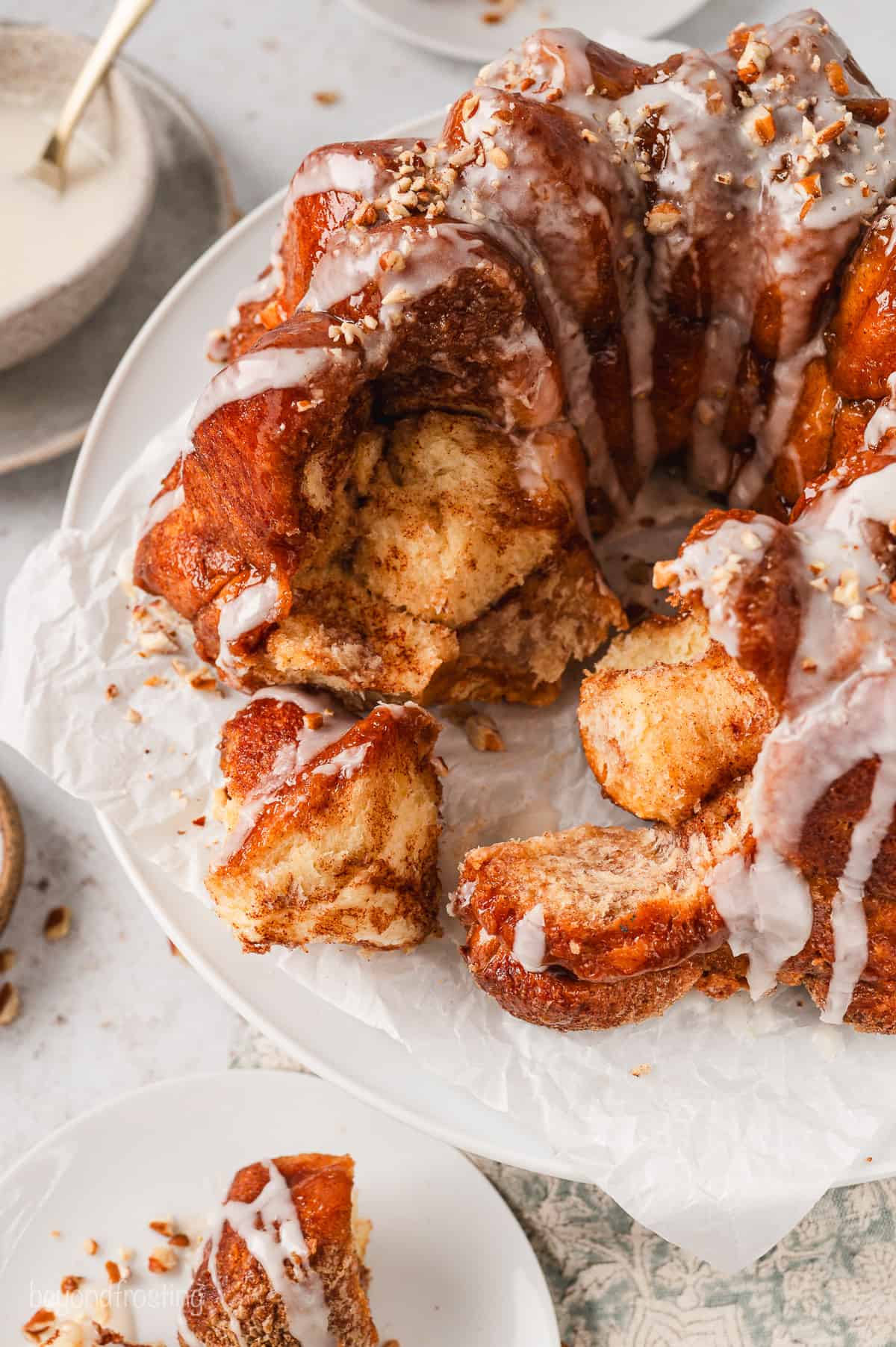 Partially torn apart monkey bread on a white plate.