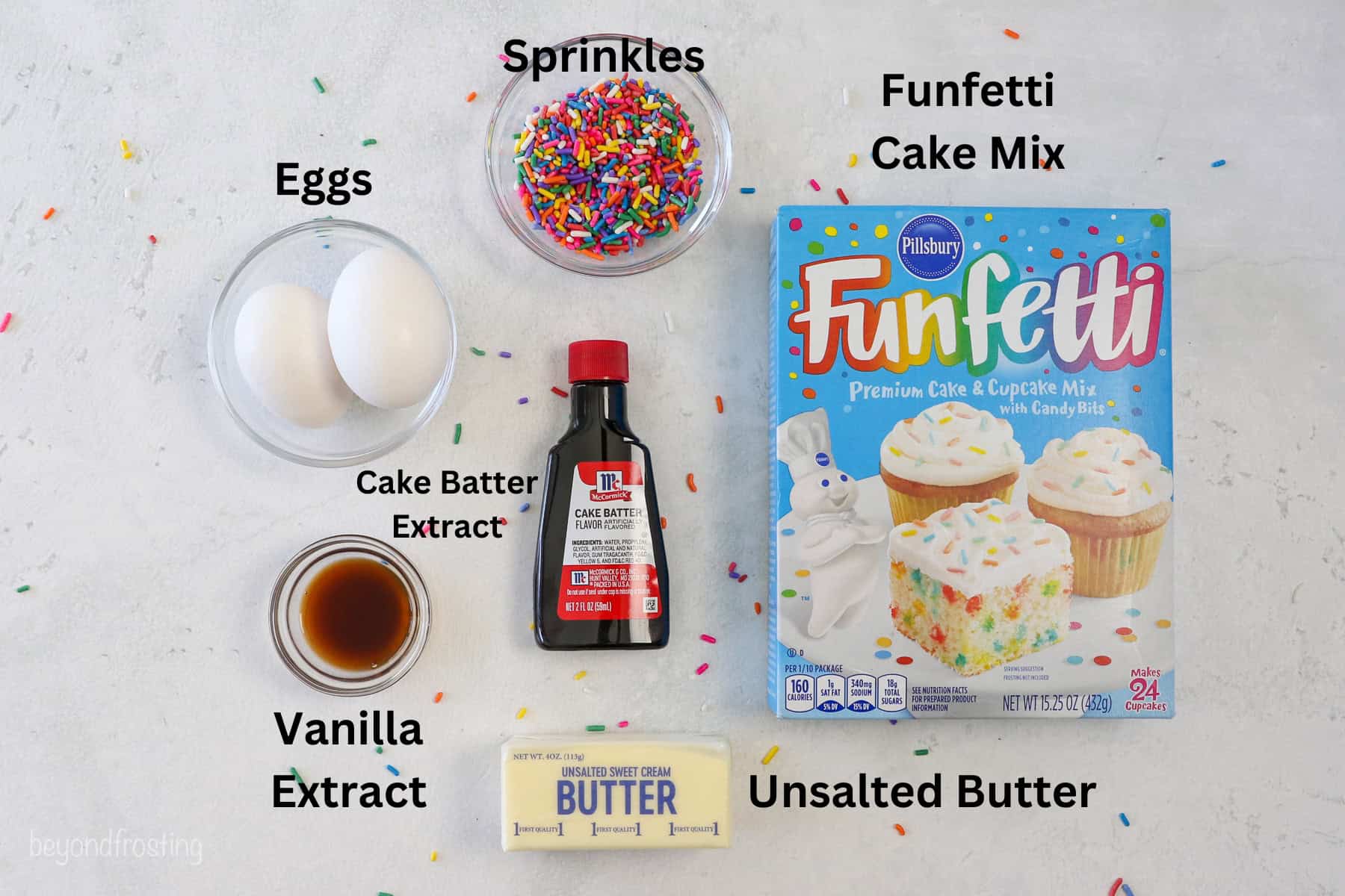 Ingredients for funfetti cake mix cookies with text labels overlaying each ingredient.