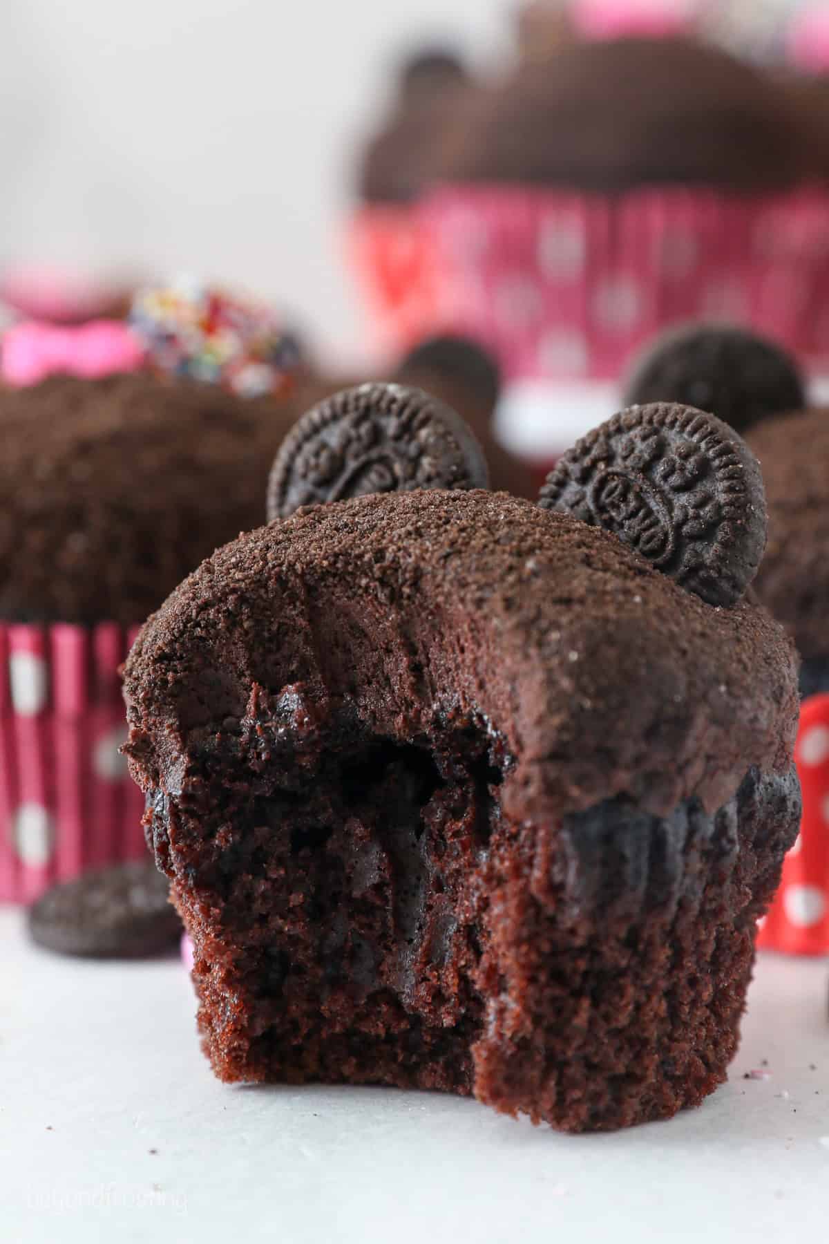 A Mickey Mouse cupcake with a bite missing.