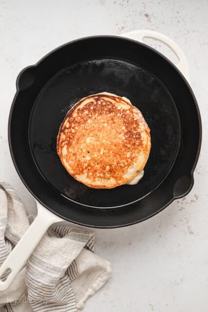 A browned buttermilk pancake in a skillet.