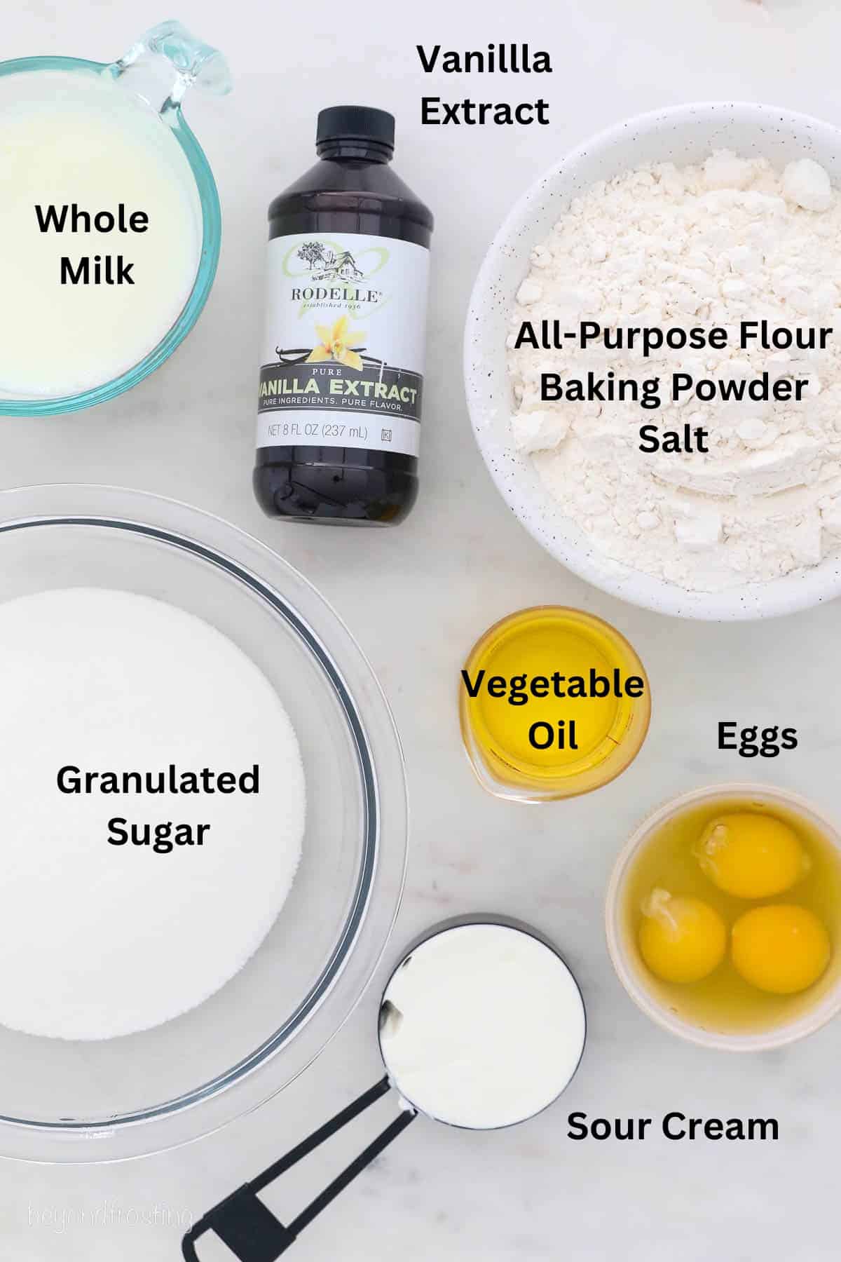The ingredients for vanilla cake laid out in bowls