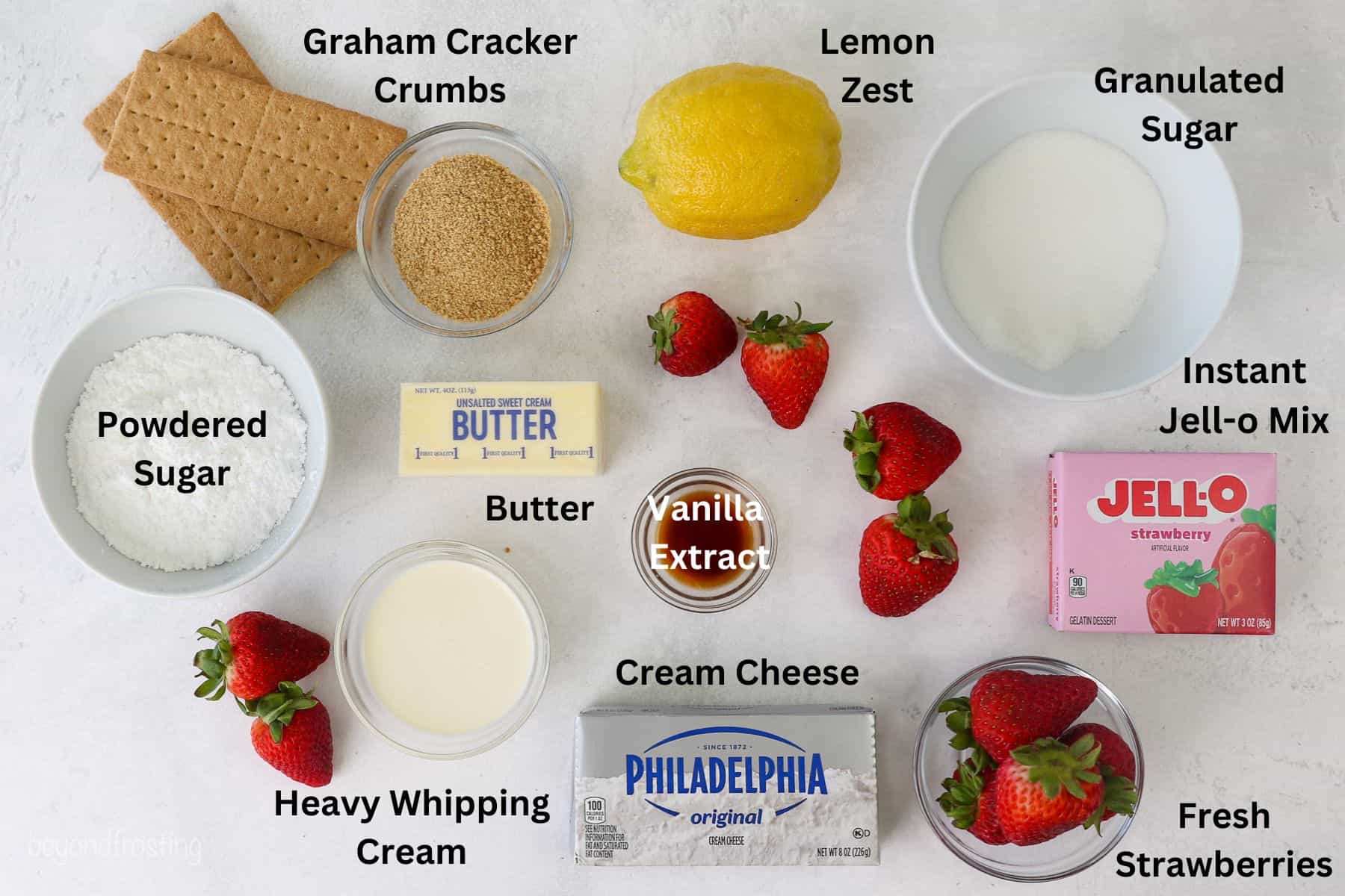 Ingredients for No-Bake Strawberry delight laid out on a texture background