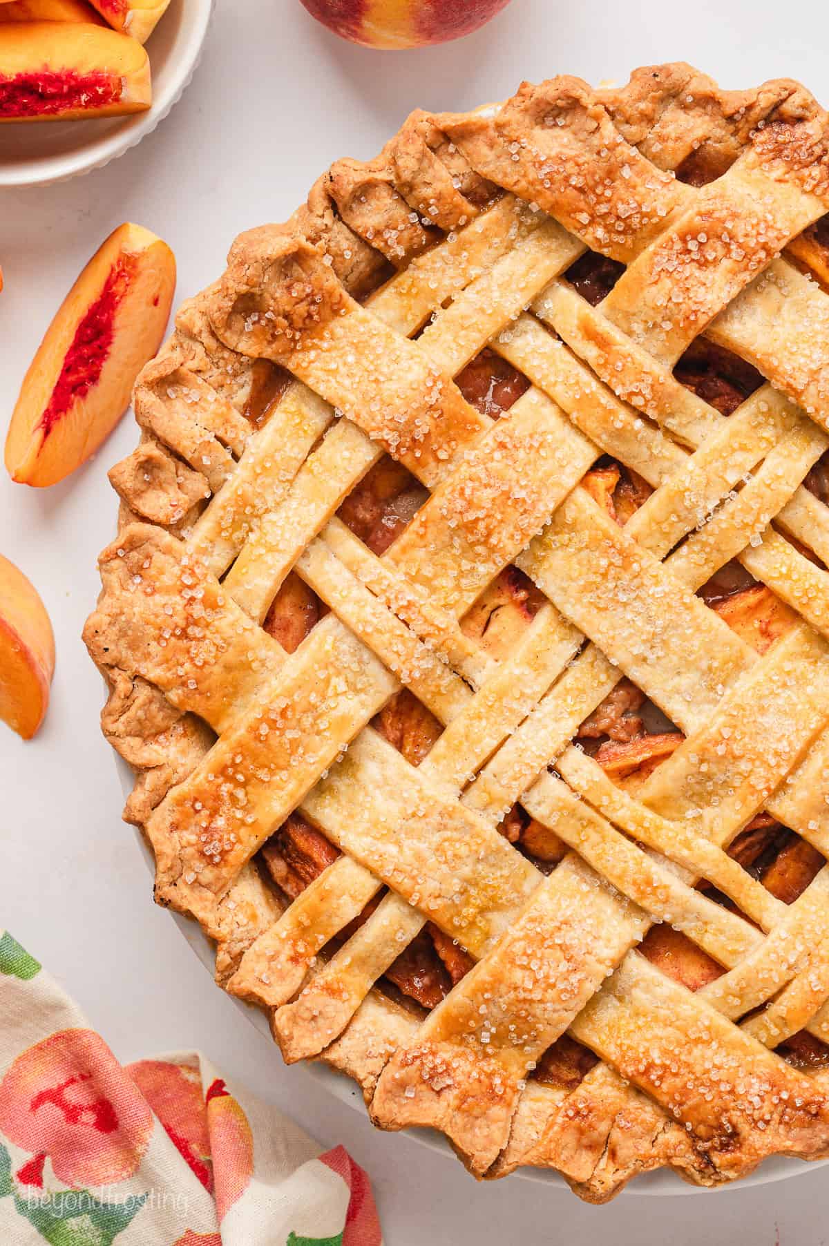 Overhead view of a peach pie with a lattice crust.