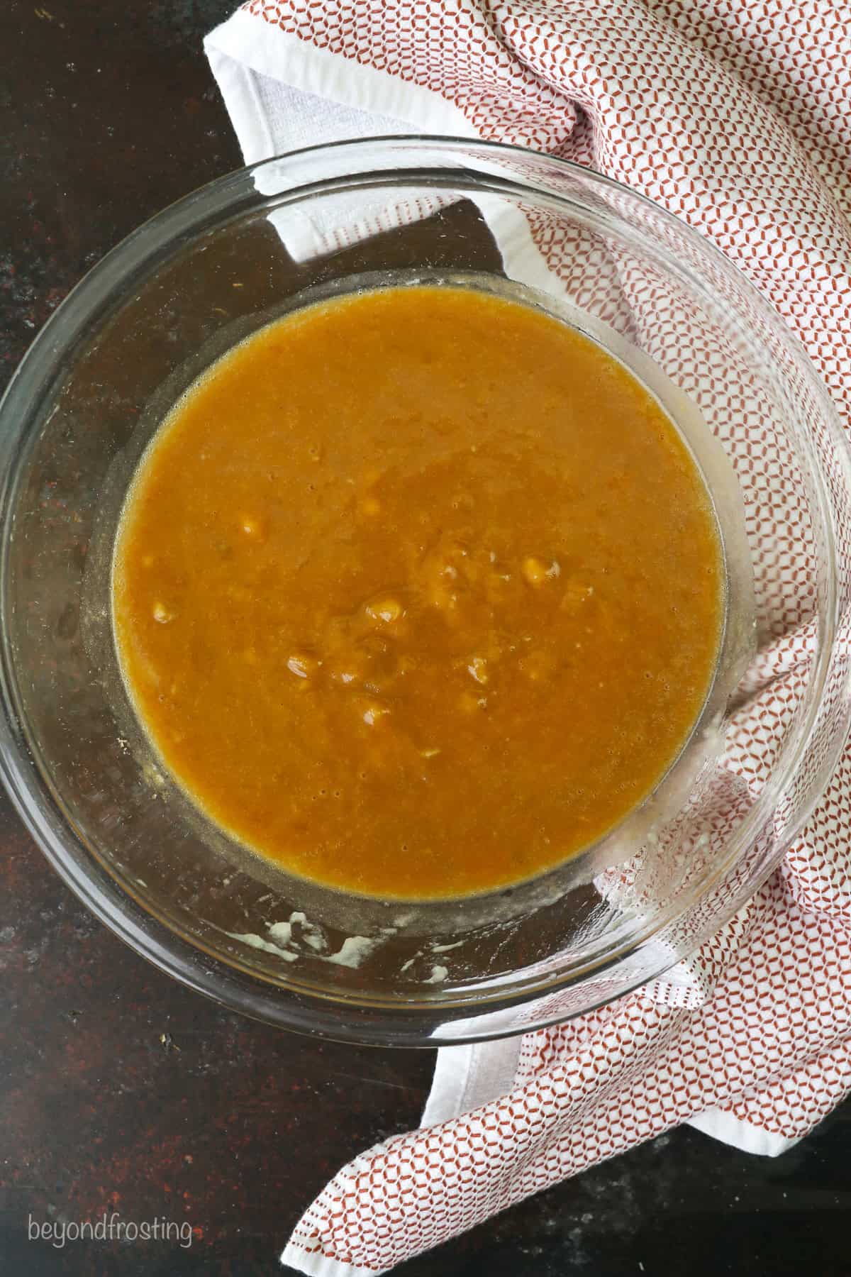 Wet ingredients combined in a glass mixing bowl.