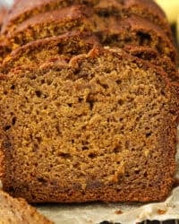 Front view of a loaf of pumpkin banana bread cut into slices.