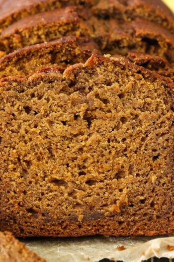 Front view of a loaf of pumpkin banana bread cut into slices.