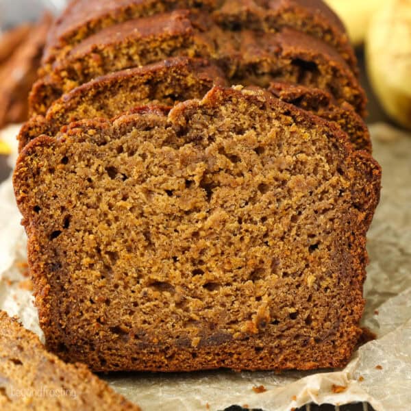 Front view of a loaf of pumpkin banana bread cut into slices.