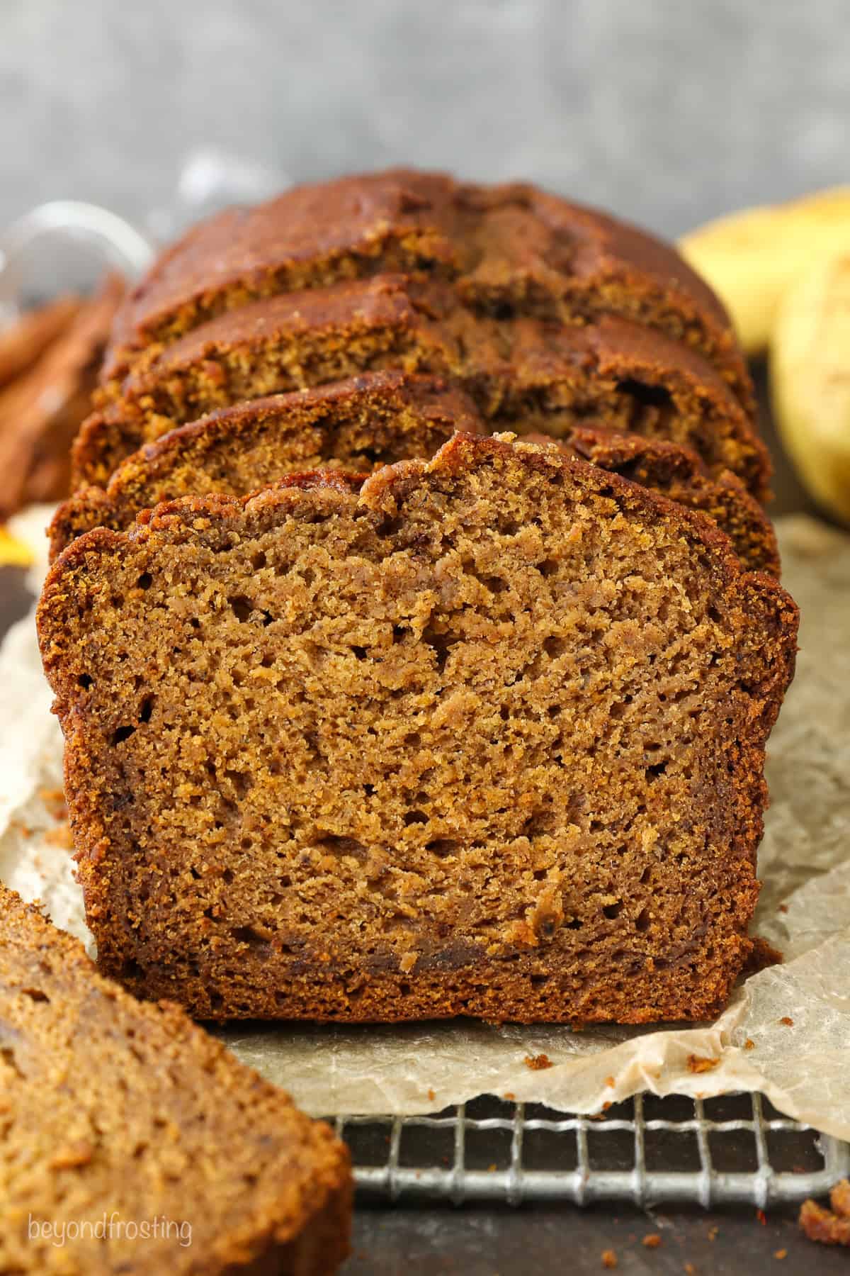 Front view of a loaf of pumpkin banana bread cut into slices.