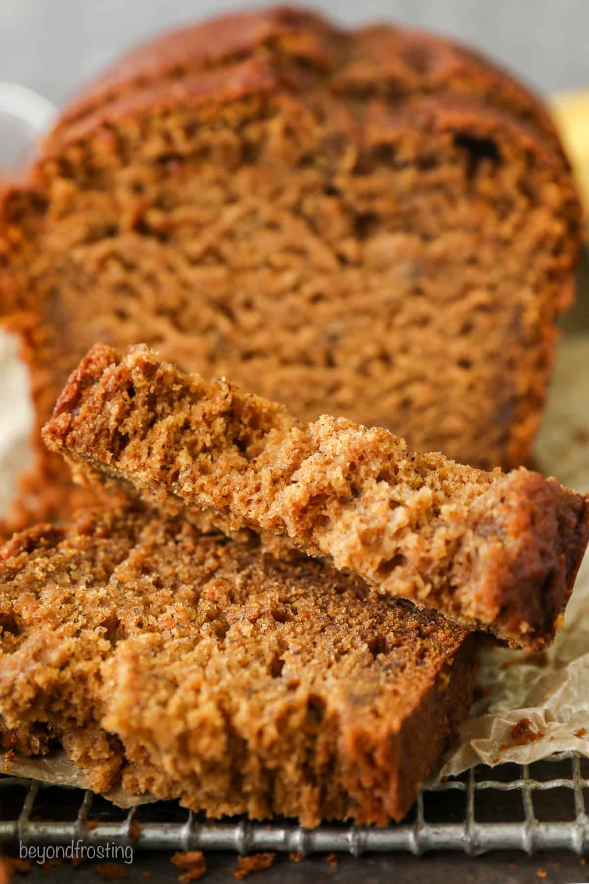 Front view of a loaf of pumpkin banana bread cut into slices.