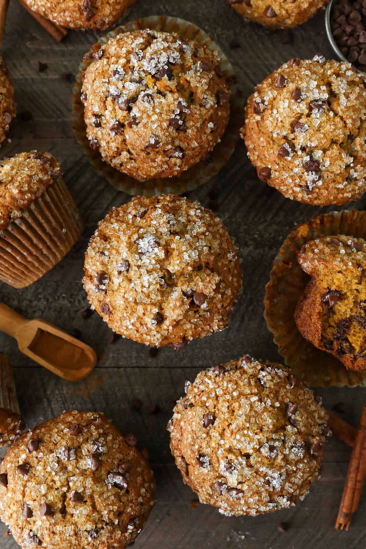 Overhead view of pumpkin chocolate chip muffins topped with sparkling sugar.