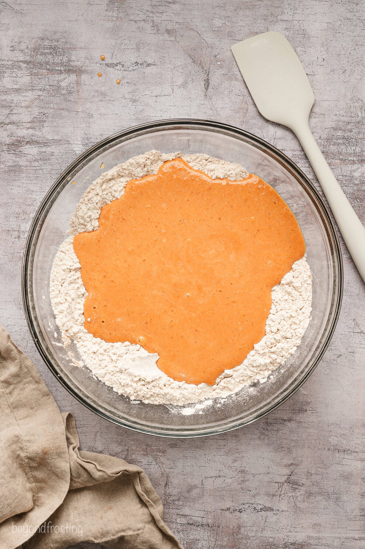 Wet pancake ingredients added to a bowl of dry ingredients.