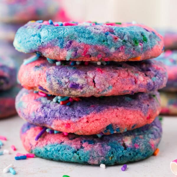 A stack of four rainbow unicorn cookies.