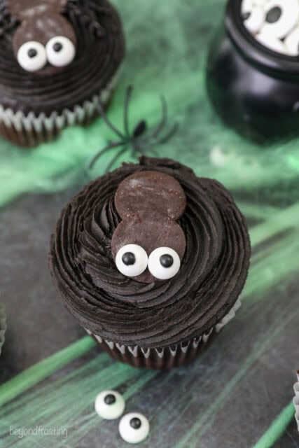 A process shot of decorating a spider cupcake for Halloween