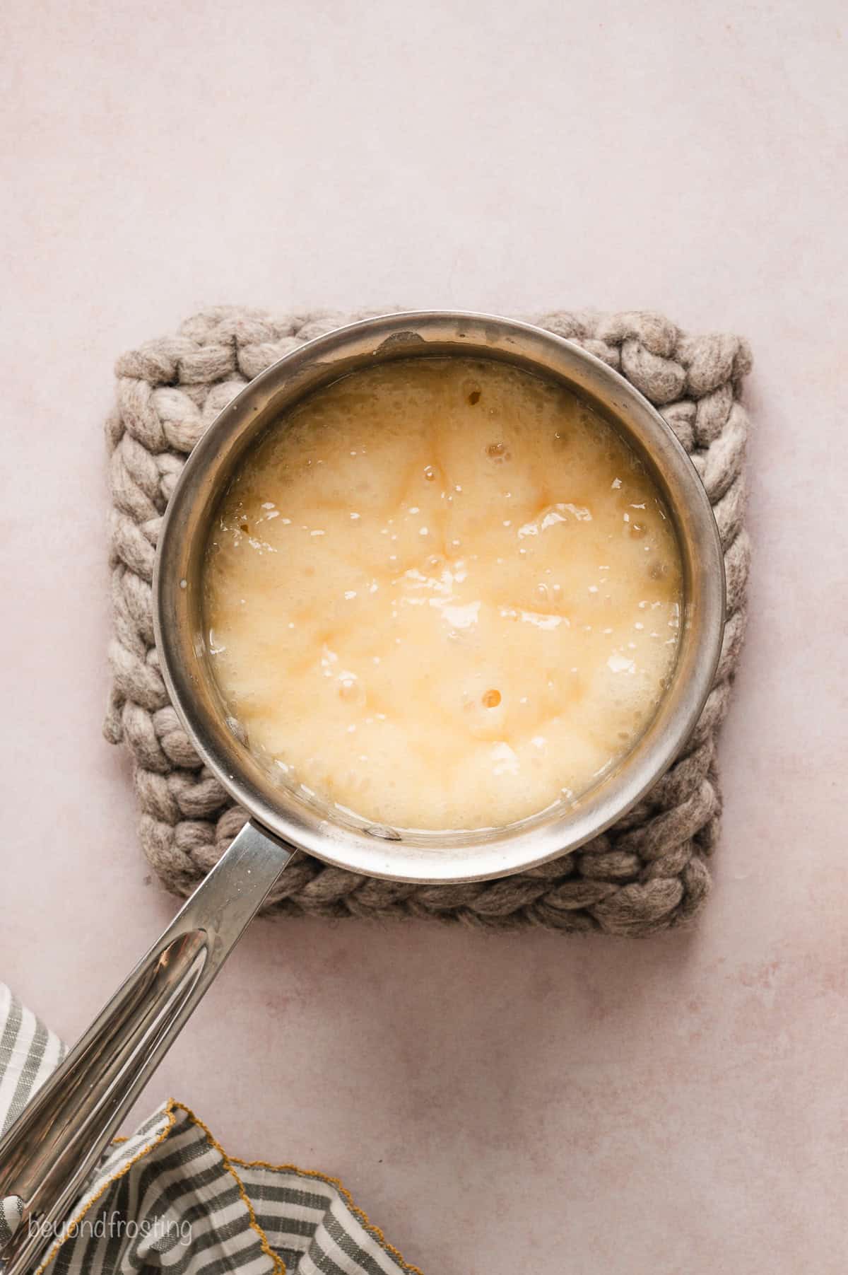 Boiling fudge syrup in a saucepan.