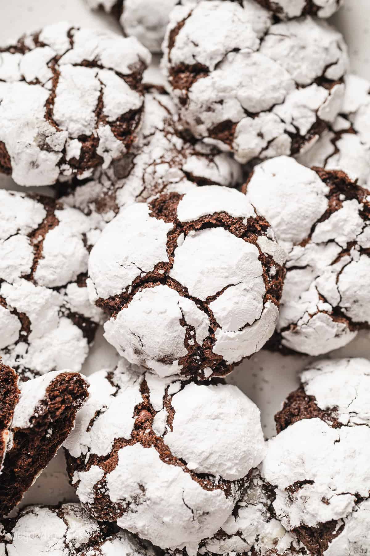 Overhead view of assorted chocolate crinkle cookies on a countertop.