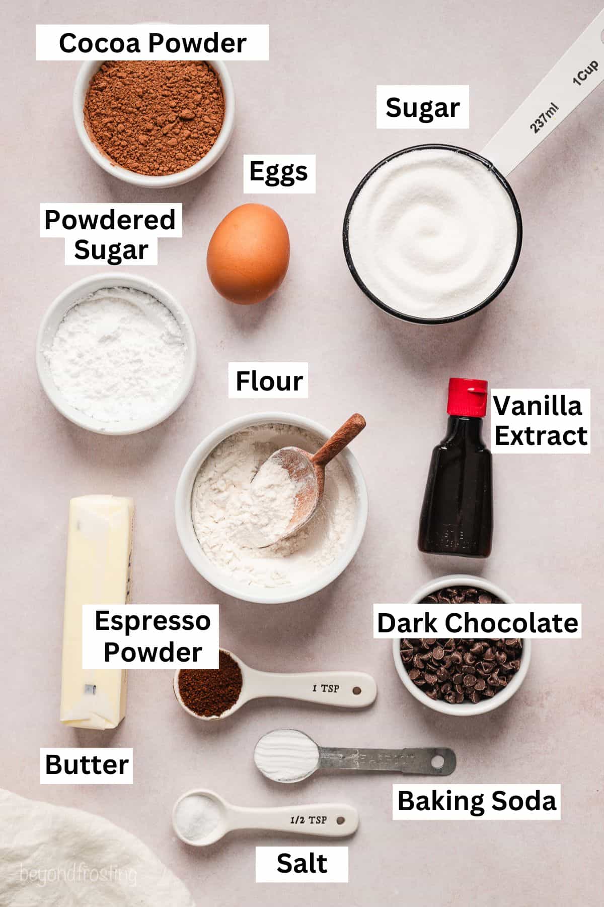 Chocolate crinkle cookie ingredients with text labels overlaying each ingredient.