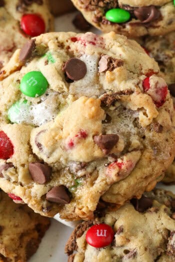 A close up of the top of a Christmas-themed Elf Cookie showing the M&Ms, chocolate chips and pools of melted marshmallows