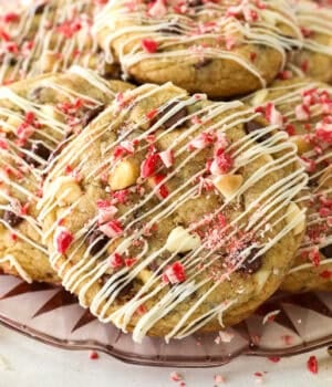 Close up of peppermint chocolate chip cookies piled on a glass plate.