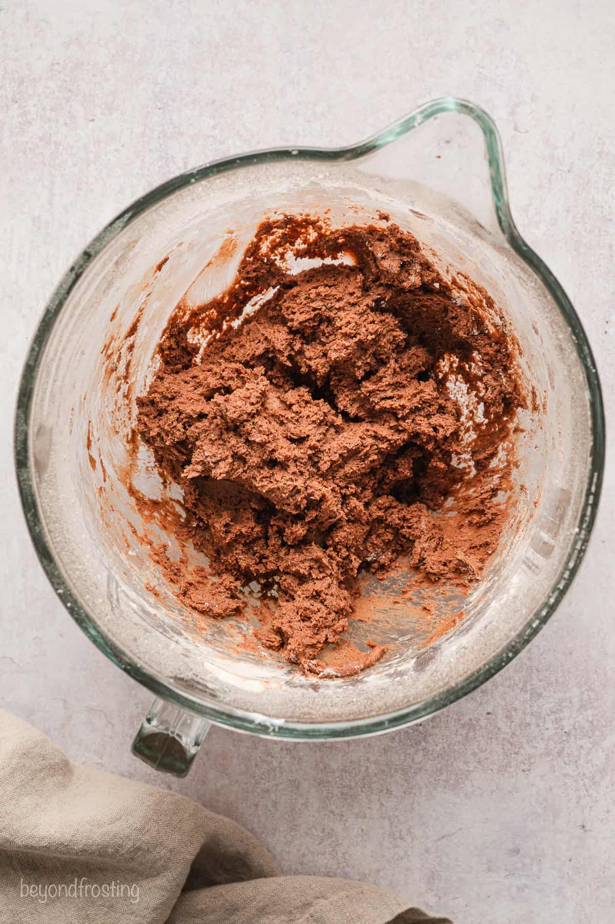 Chocolate donut dough in a mixing bowl.