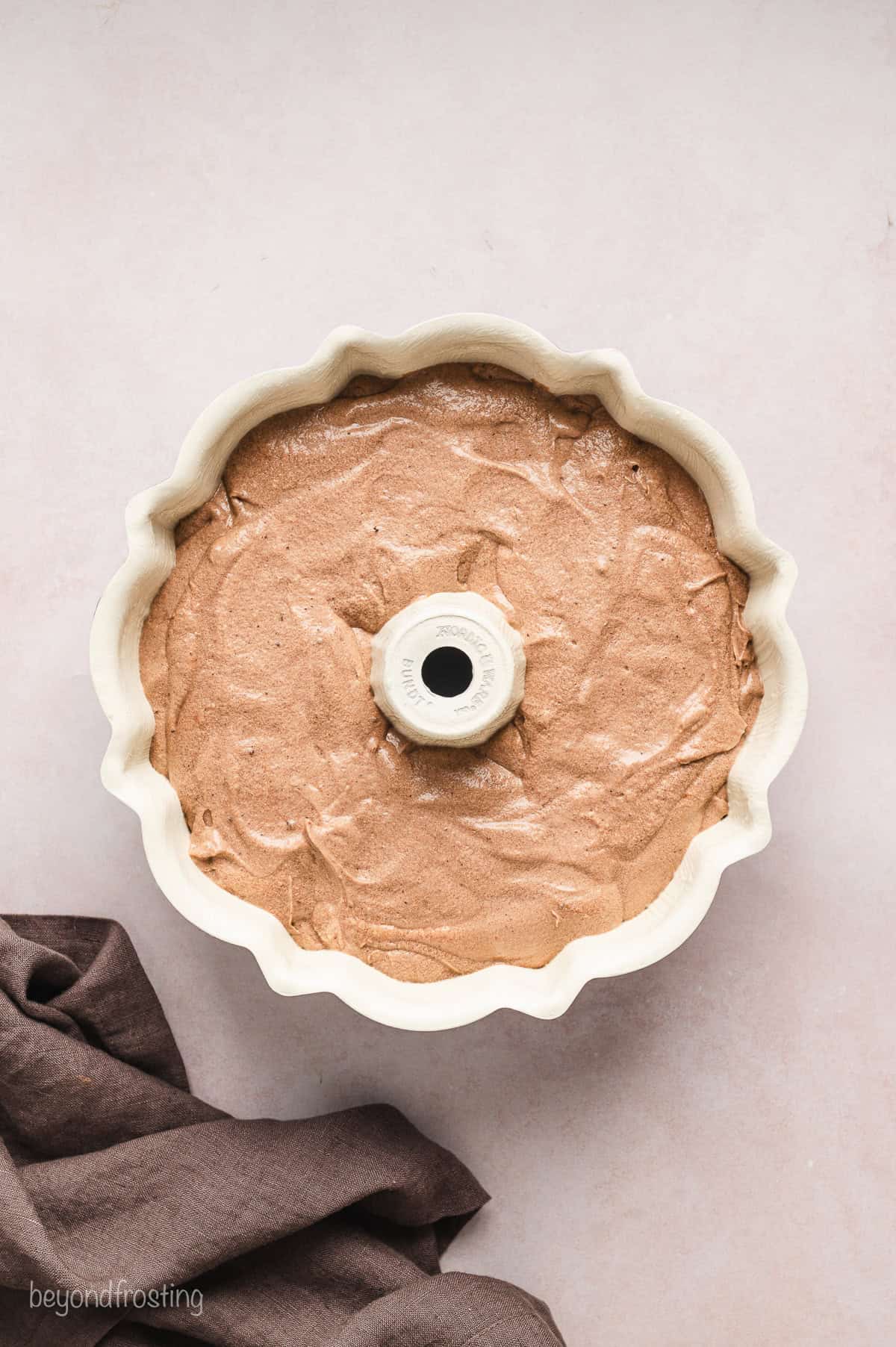 A bundt pan filled with chocolate cake batter.