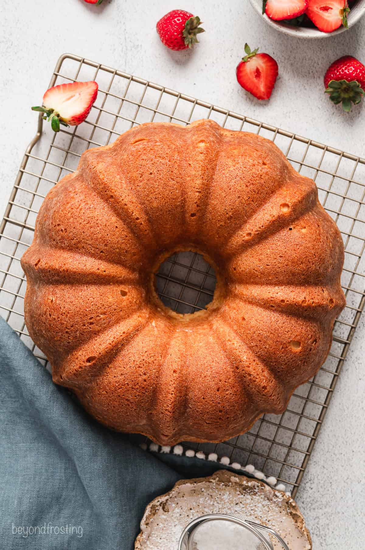 Baked cream cheese pound cake inverted onto a wire rack.