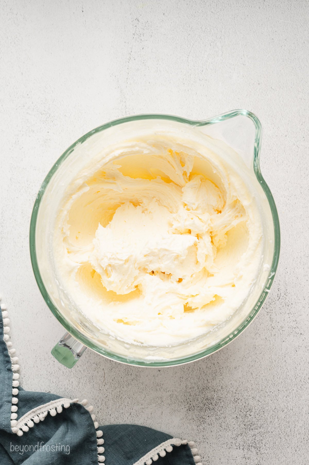 Butter, cream cheese, and sugar beaten together in a mixing bowl.