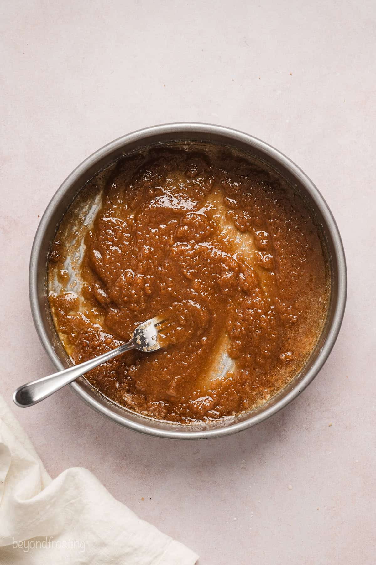 Brown sugar mixture spread into the bottom of a cake pan.