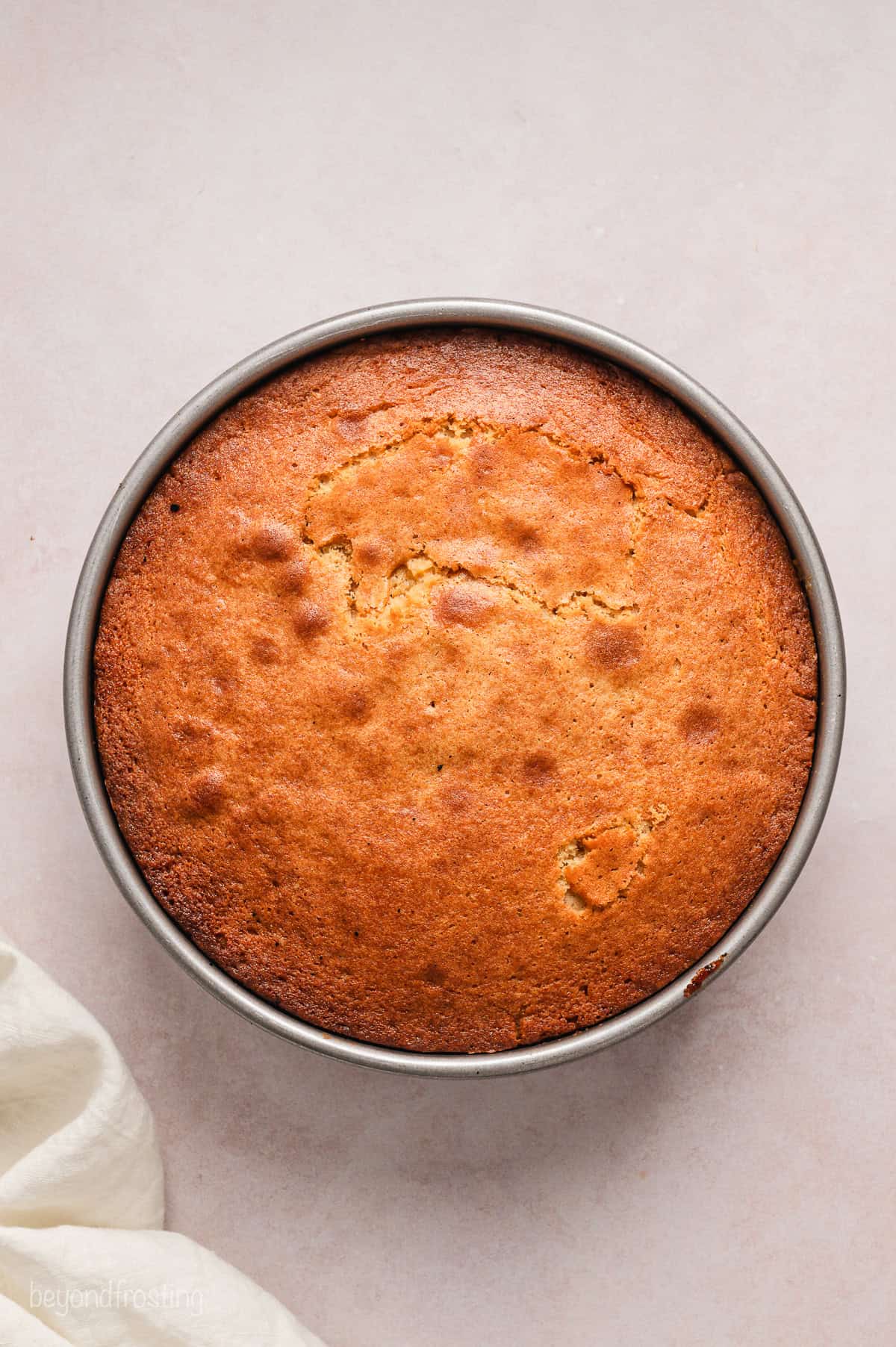 Baked upside down cake inside a round cake pan.