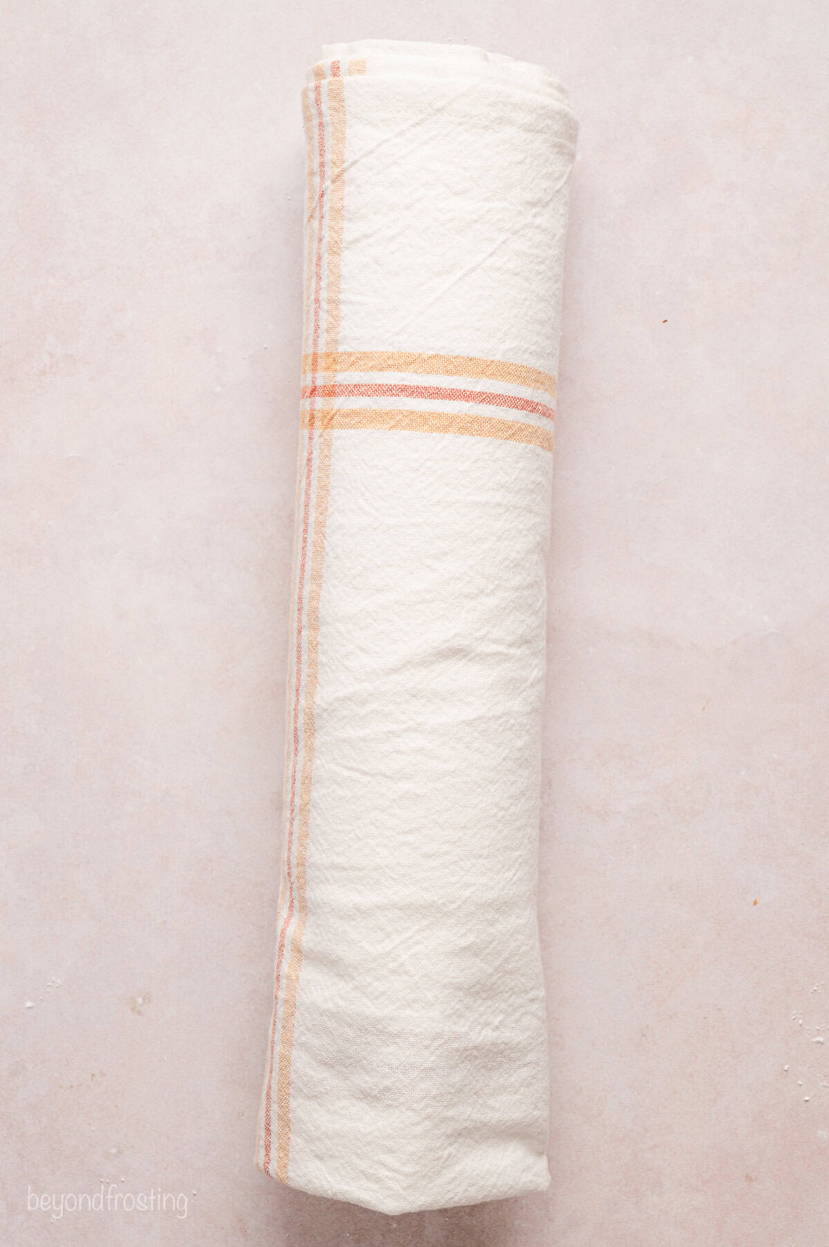 Chocolate cake rolled up inside a clean dish towel.