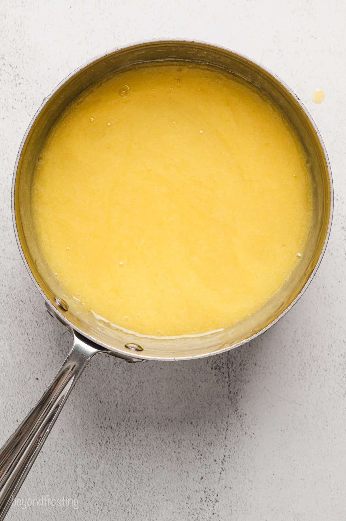 Lemon curd filling in a saucepan.