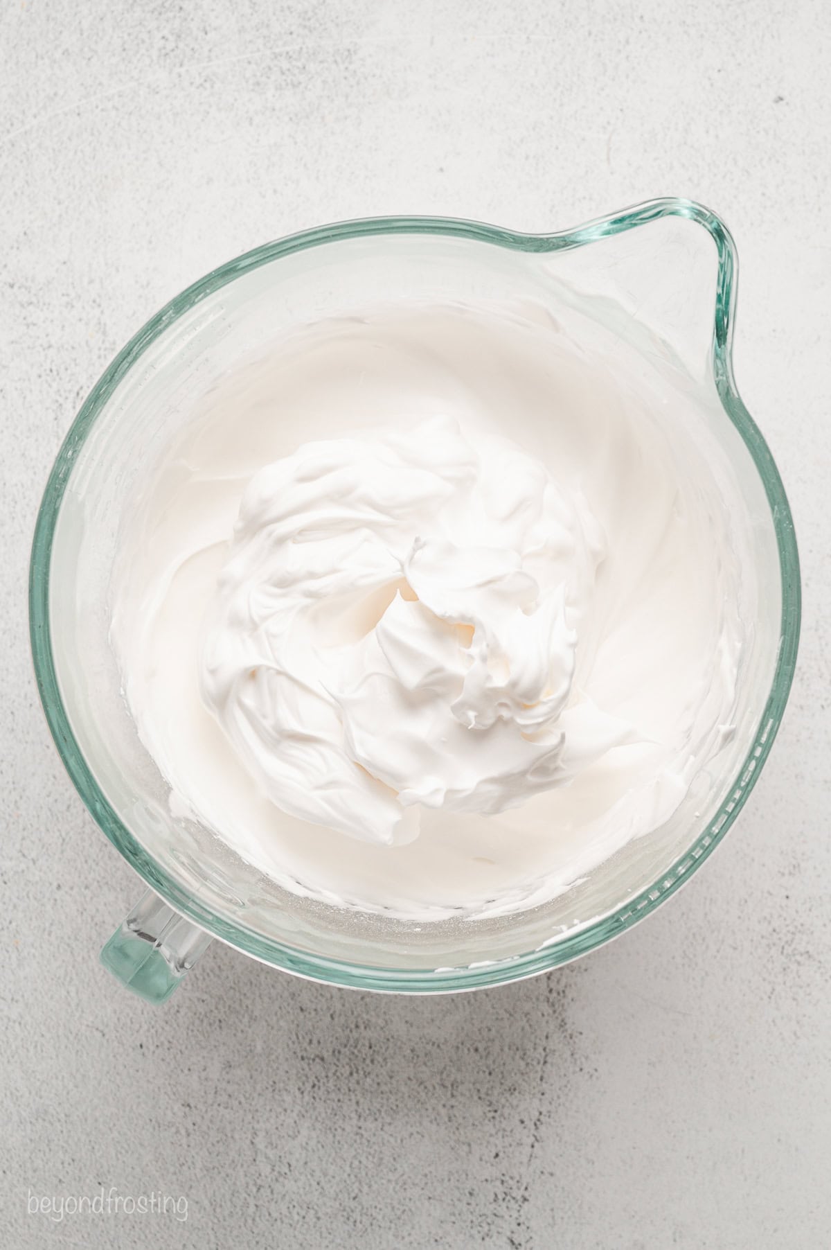 Whipped meringue in a glass bowl.