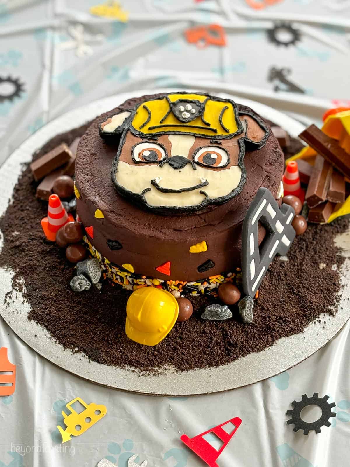 A buttercream decorated small cake with a Paw Patrol theme featuring Rubble.