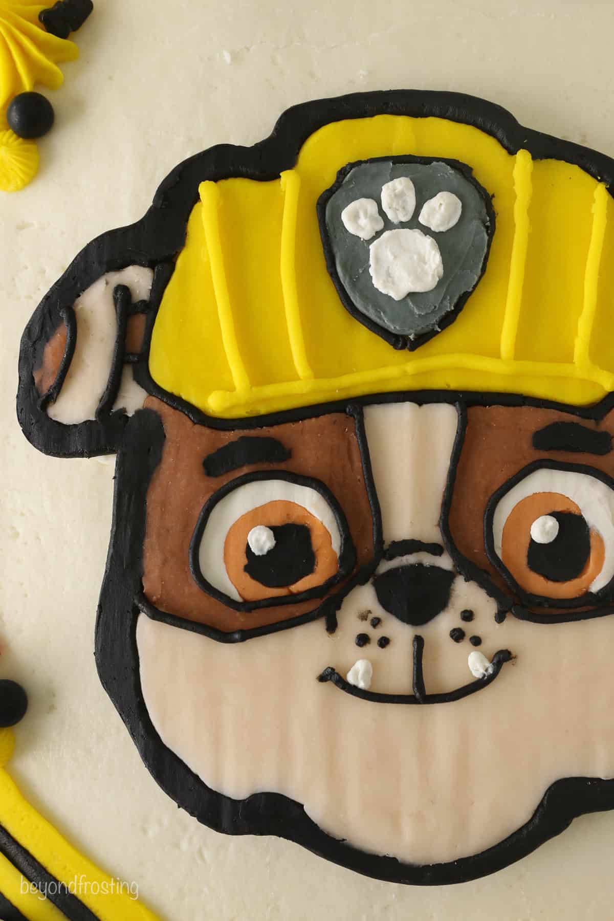 Close up of a Paw Patrol cake with Rubble's face in the center.