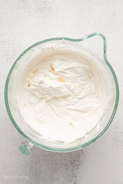 Whipped cream cheese frosting in a mixing bowl.