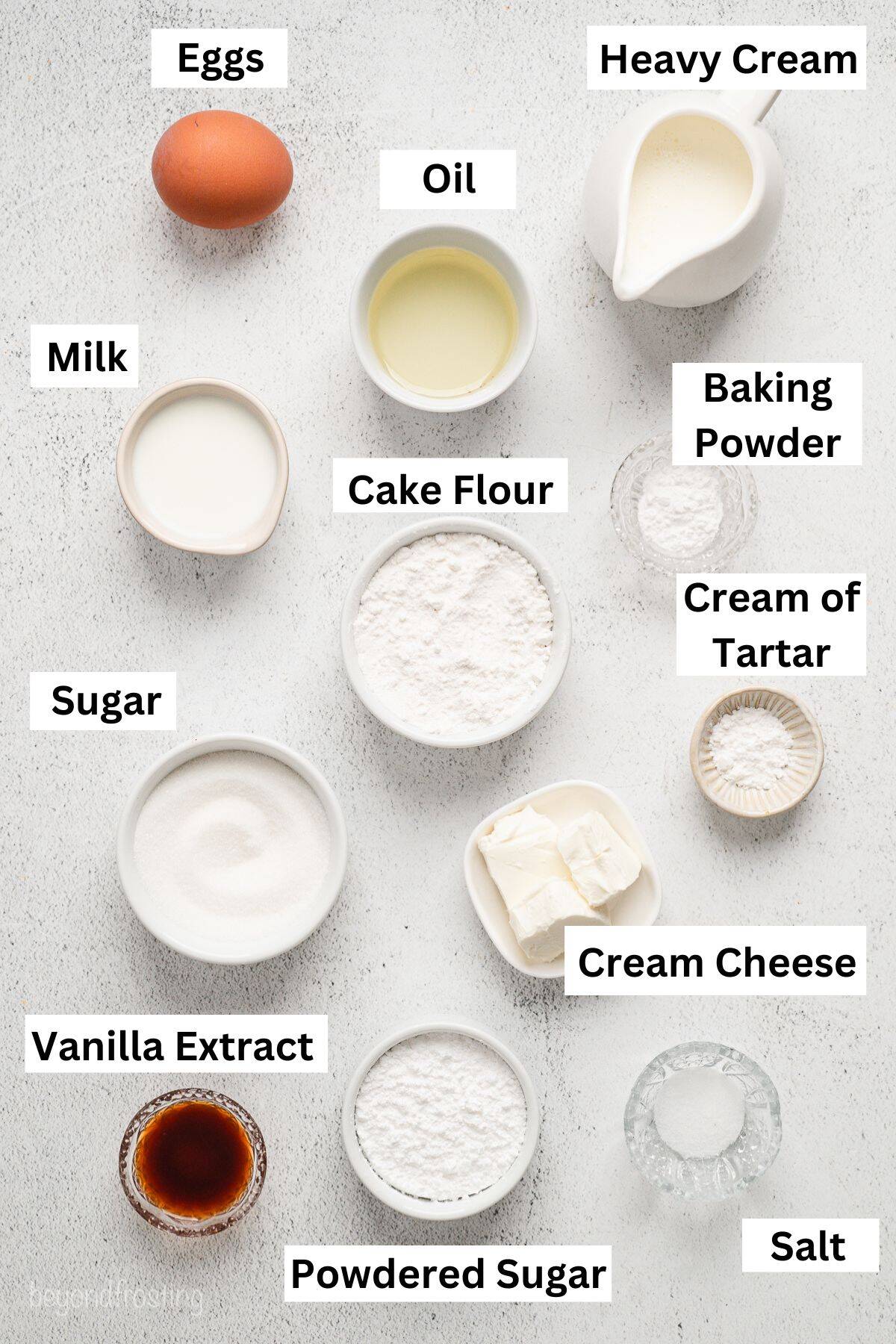 Ingredients for Vanilla cake roll laid out in assorted bowls and cups