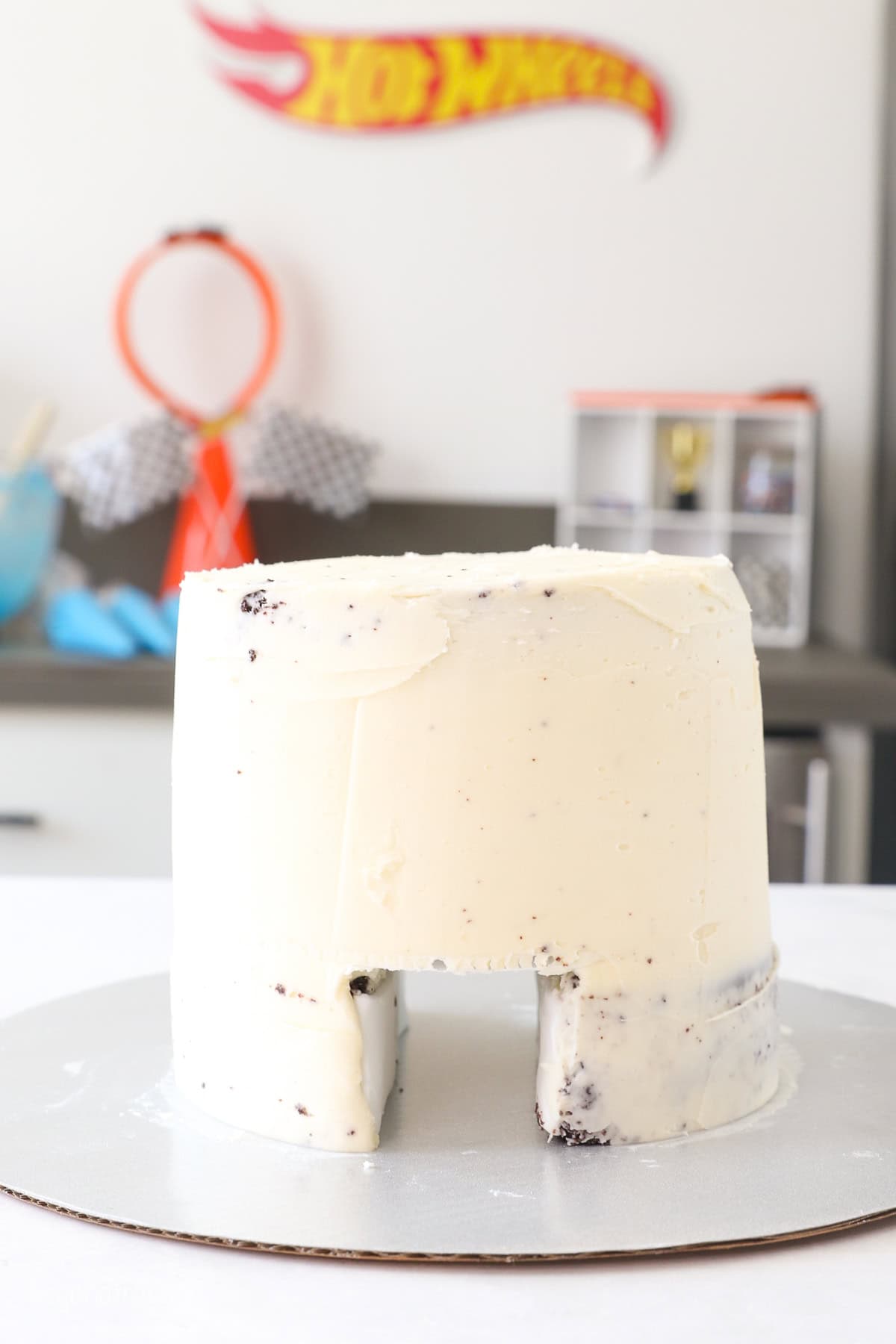 A layer cake with a tunnel through the bottom frosted with vanilla buttercream.